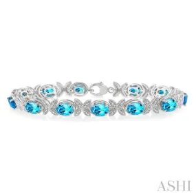 1/10 Ctw Round Cut Diamond & 7x5MM Oval Cut Blue Topaz Semi Precious Bracelet in Sterling Silver